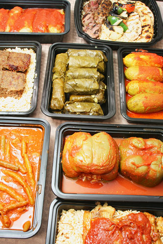 Trays of stuffed peppers, grape leaves, kibbie, kebabs and stuffed squash