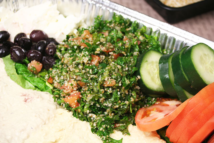 Thaboule with hummus, olives, cucumbers and tomatoes